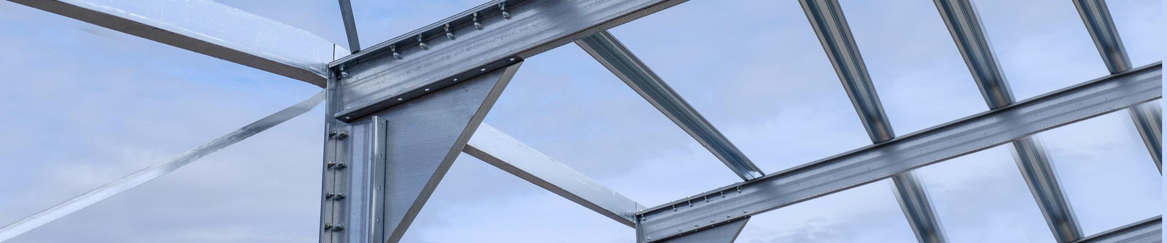 Steel framework against a blue sky with a few scattered clouds